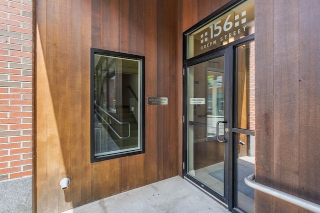 doorway to property with brick siding