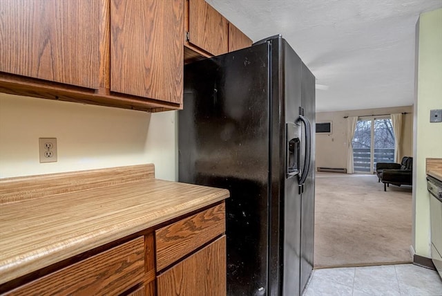 kitchen featuring light colored carpet, black refrigerator with ice dispenser, and a baseboard radiator