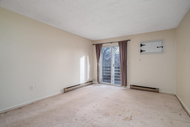 carpeted spare room featuring a baseboard heating unit