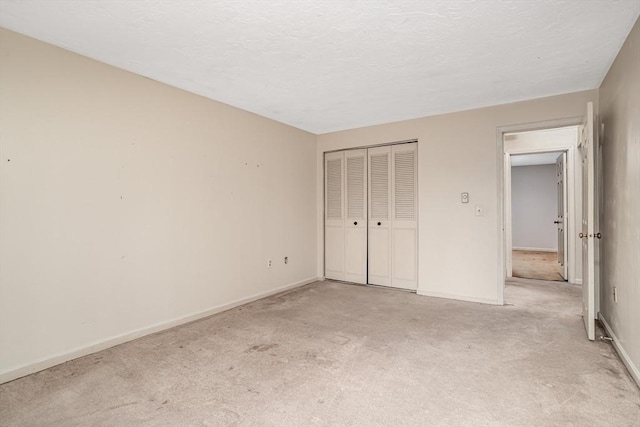 unfurnished bedroom featuring a closet and light carpet