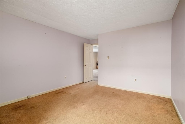 carpeted empty room with a textured ceiling