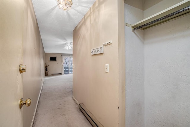 corridor with a baseboard heating unit and light carpet