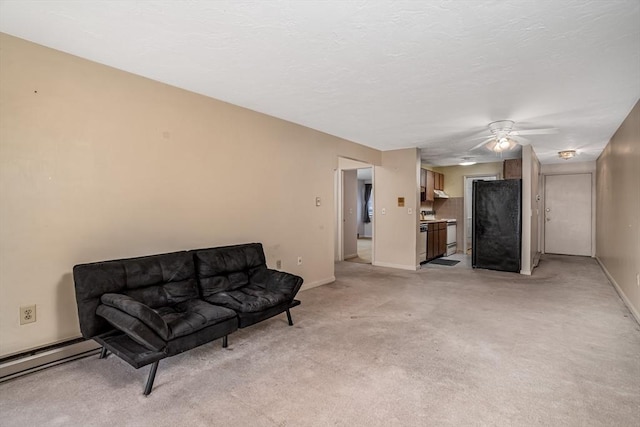 sitting room featuring ceiling fan, light carpet, and a baseboard heating unit