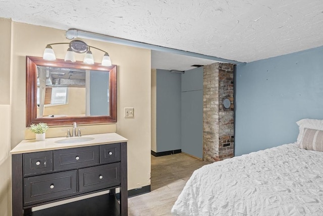 34 Prout St, Quincy, MA 02169 - bedroom with a sink, a textured ceiling, light wood-type flooring, and baseboards