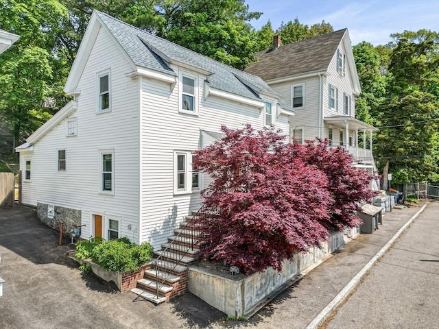 34 Prout St, Quincy, MA 02169 - view of home's exterior featuring stairway and a shingled roof