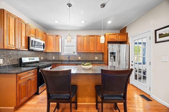 34 Prout St, Quincy, MA 02169 - kitchen featuring stainless steel appliances, a sink, a kitchen breakfast bar, tasteful backsplash, and recessed lighting