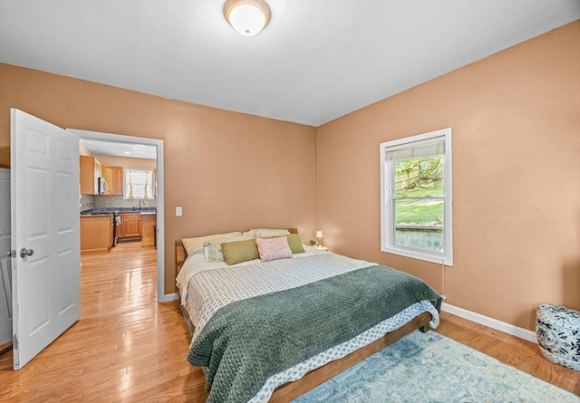 34 Prout St, Quincy, MA 02169 - bedroom featuring multiple windows, light wood-type flooring, baseboards, and a sink