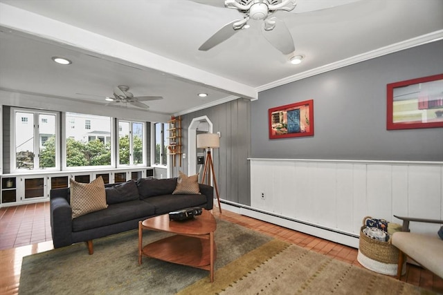 living room featuring crown molding, ceiling fan, a baseboard heating unit, and wood finished floors