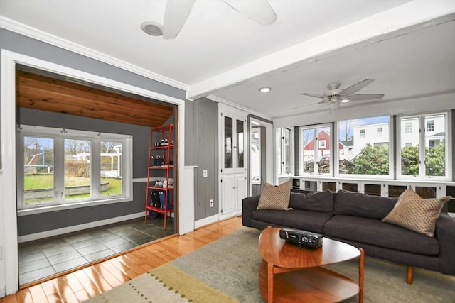 living room with hardwood / wood-style floors, ceiling fan, beamed ceiling, and plenty of natural light