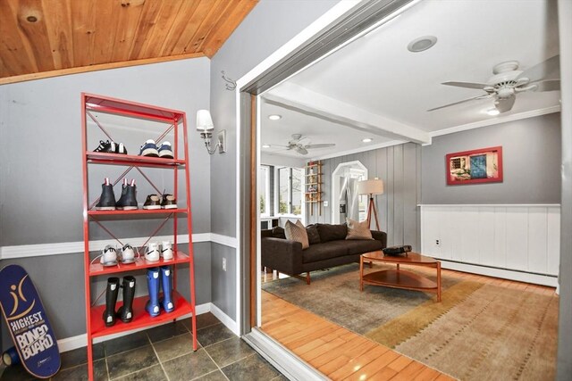 sitting room featuring baseboard heating, baseboards, recessed lighting, crown molding, and ceiling fan