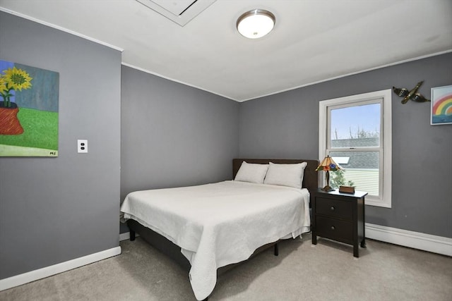 bedroom with crown molding, baseboards, and carpet flooring