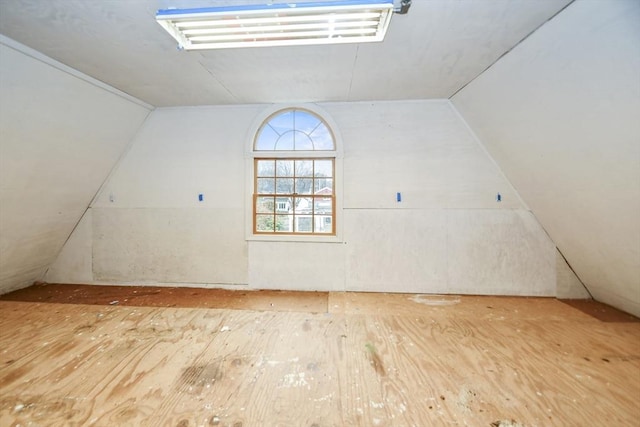 bonus room with wood-type flooring and lofted ceiling