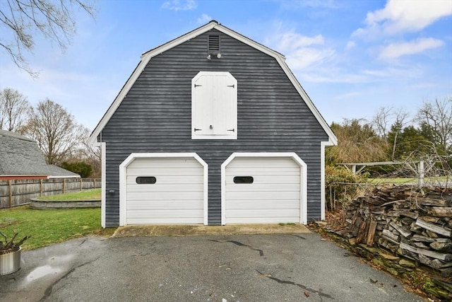 garage with a garage and fence