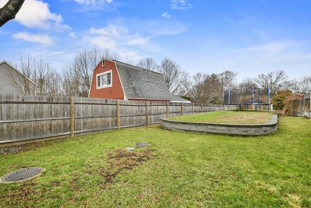 view of yard featuring a trampoline and a fenced backyard