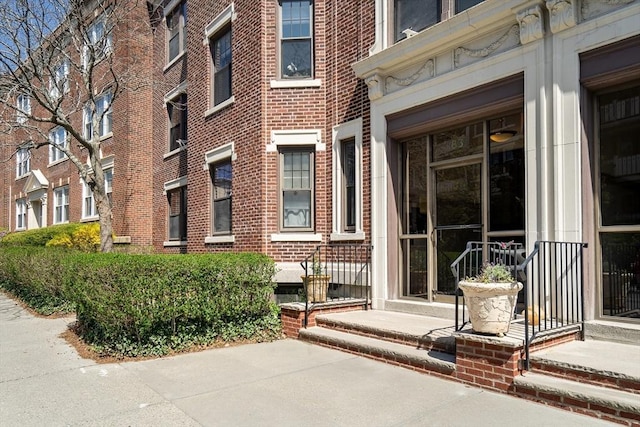 doorway to property with brick siding