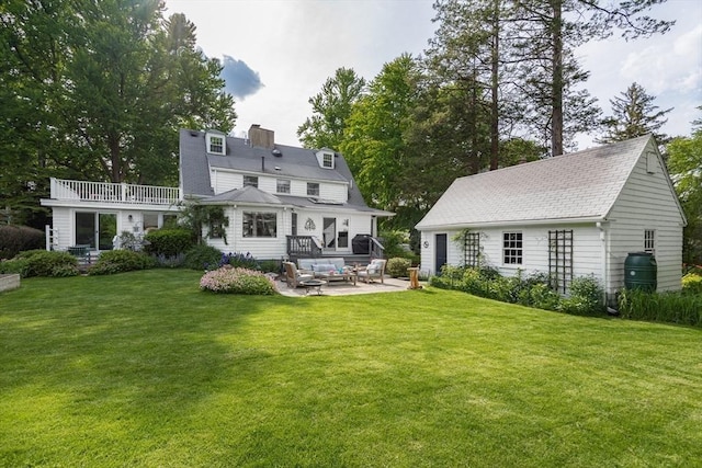40 Stone Rd, Belmont, MA 02478 - back of property featuring a patio, an outdoor hangout area, a chimney, and a yard