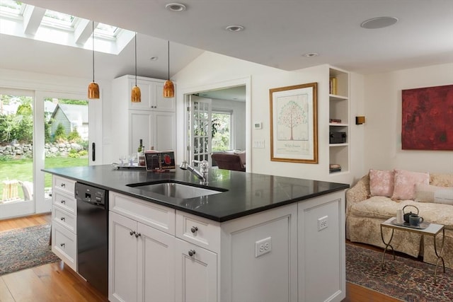 40 Stone Rd, Belmont, MA 02478 - kitchen with a sink, dishwasher, a skylight, light wood-type flooring, and vaulted ceiling