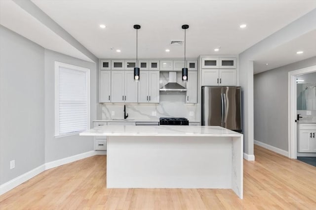 755 Boylston St Unit 2, Brookline, MA 02467 - kitchen featuring freestanding refrigerator, wall chimney exhaust hood, baseboards, a sink, and a kitchen island