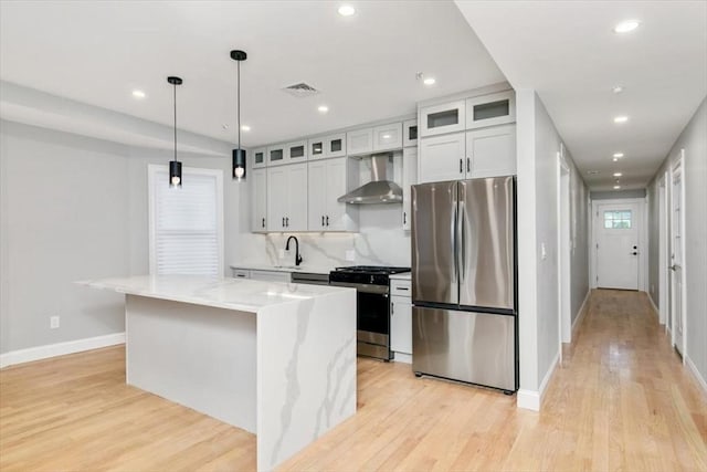 755 Boylston St Unit 2, Brookline, MA 02467 - kitchen featuring stainless steel appliances, wall chimney exhaust hood, baseboards, light wood-style flooring, and recessed lighting