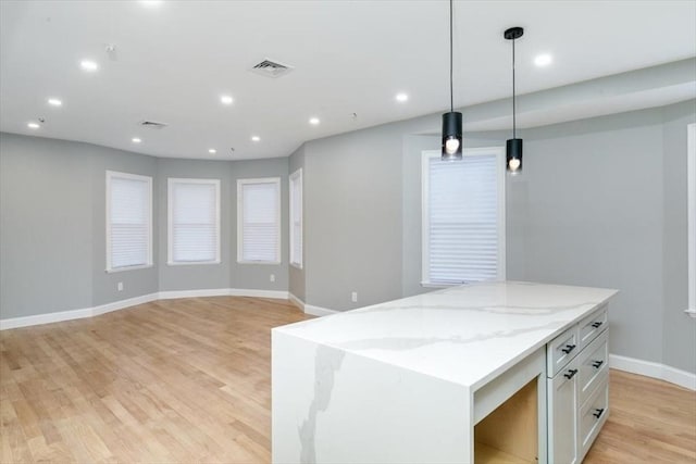 755 Boylston St Unit 2, Brookline, MA 02467 - kitchen featuring white cabinetry, baseboards, light stone countertops, light wood-type flooring, and recessed lighting