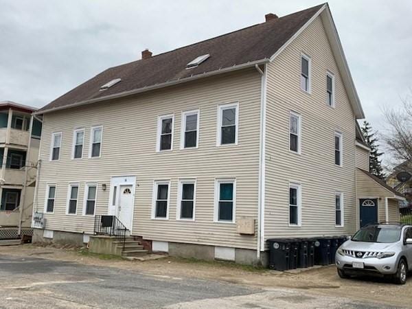 view of front of house featuring a chimney