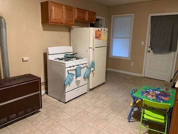 kitchen with white appliances and brown cabinets