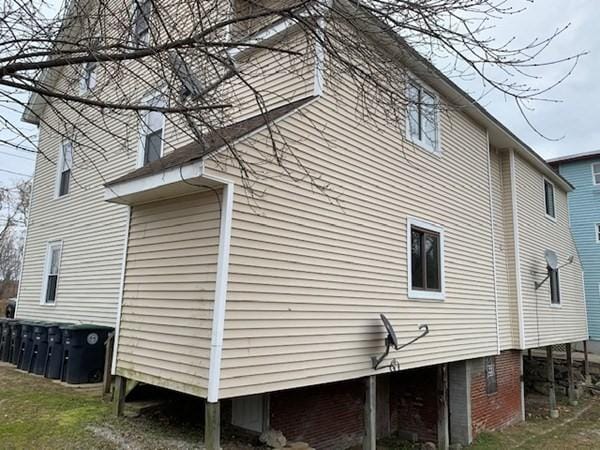 view of side of home featuring a yard