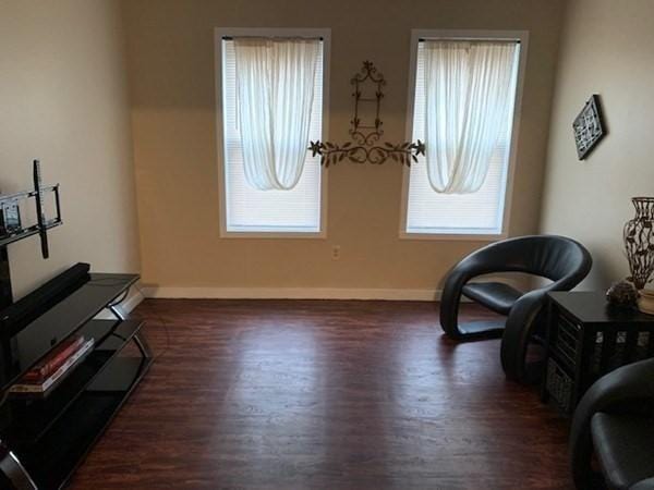 sitting room with wood finished floors and baseboards
