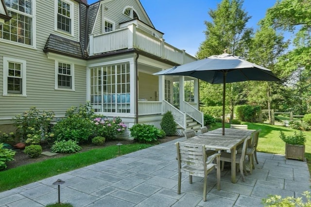 view of patio with outdoor dining space and a balcony