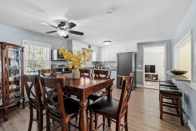 dining room featuring a ceiling fan and wood finished floors