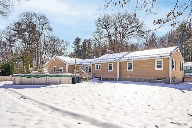 view of snow covered back of property