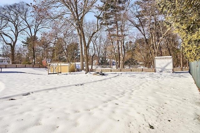 snowy yard with fence