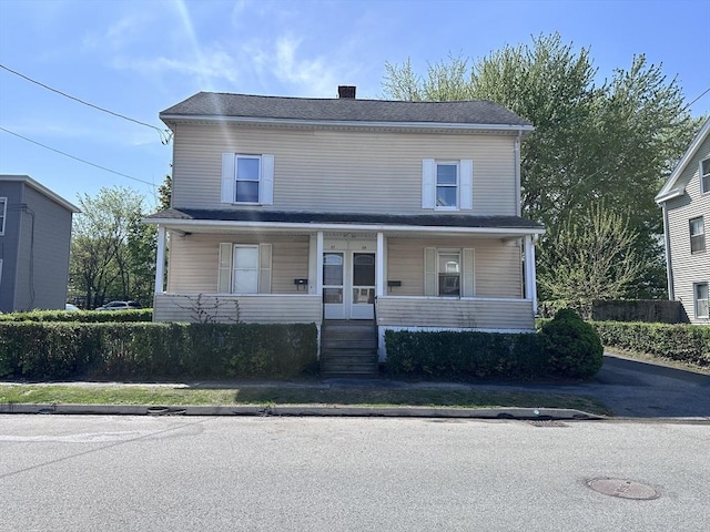 view of front of house with a porch and a chimney