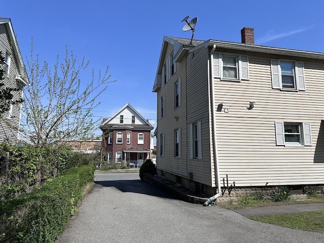 view of side of home featuring a chimney