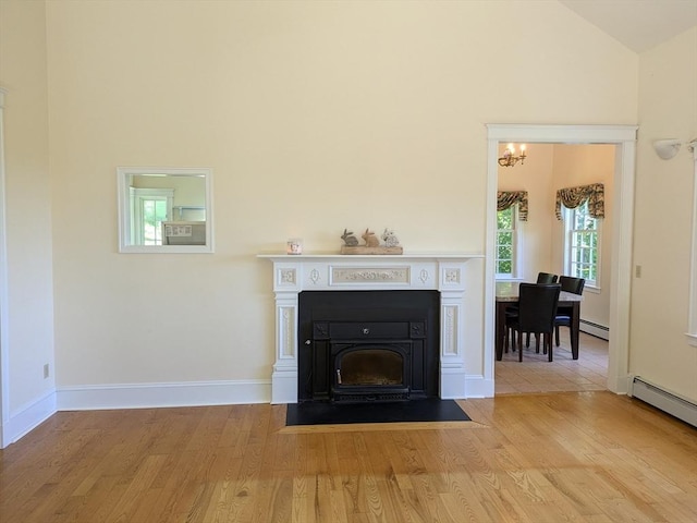 134 Mountain Rd, Princeton, MA 01541 - detailed view of a chandelier, wood finished floors, a fireplace with flush hearth, and a baseboard radiator