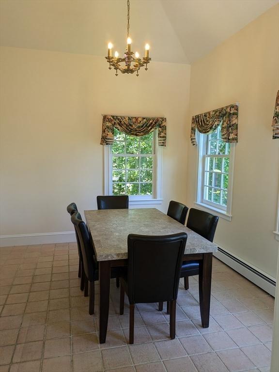 134 Mountain Rd, Princeton, MA 01541 - dining space featuring baseboard heating, a chandelier, plenty of natural light, light tile patterned floors, and high vaulted ceiling