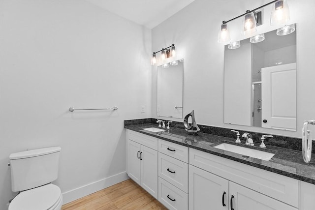 bathroom with vanity, wood-type flooring, an enclosed shower, and toilet