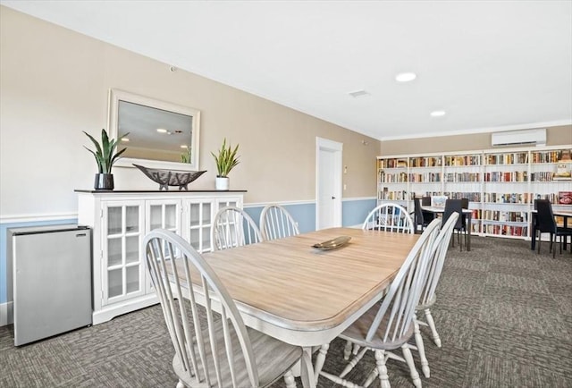 dining area featuring dark carpet and a wall unit AC