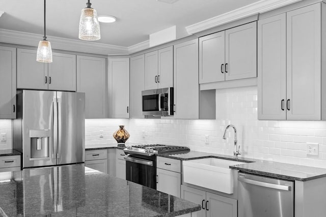 kitchen featuring stainless steel appliances, dark stone counters, and tasteful backsplash