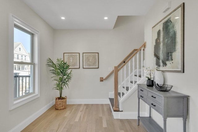 interior space featuring recessed lighting, baseboards, a wealth of natural light, and wood finished floors