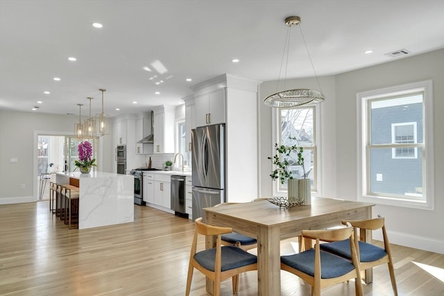 dining area with recessed lighting, plenty of natural light, and light wood-style flooring