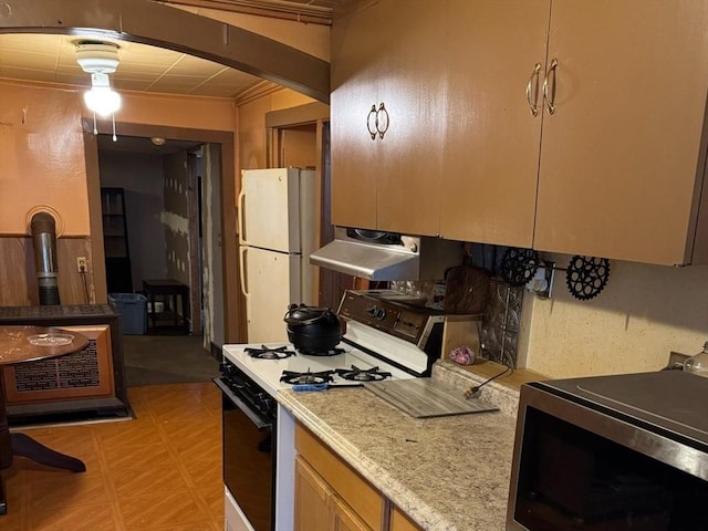 kitchen with white refrigerator and range with gas cooktop