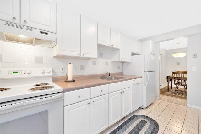 kitchen with white appliances, sink, pendant lighting, white cabinets, and light tile patterned flooring