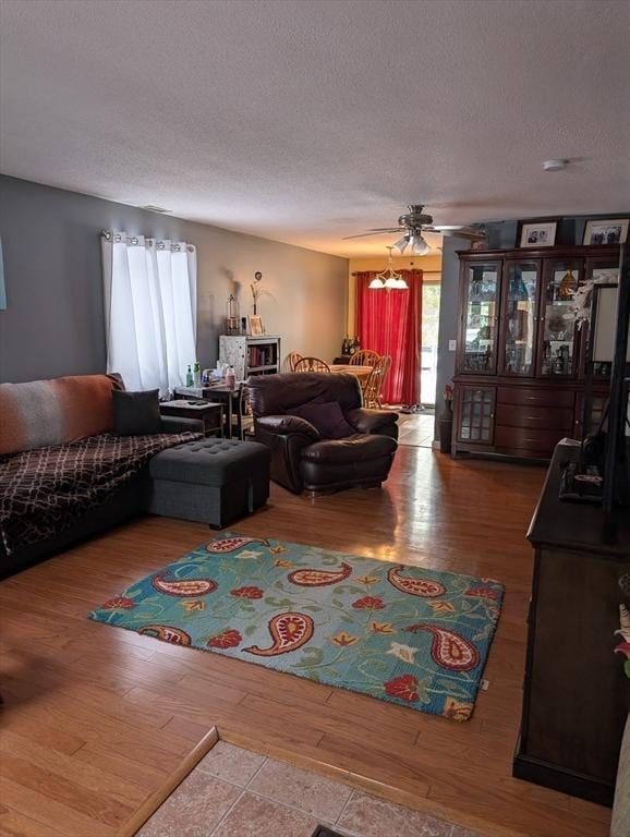 living room with hardwood / wood-style floors and a textured ceiling