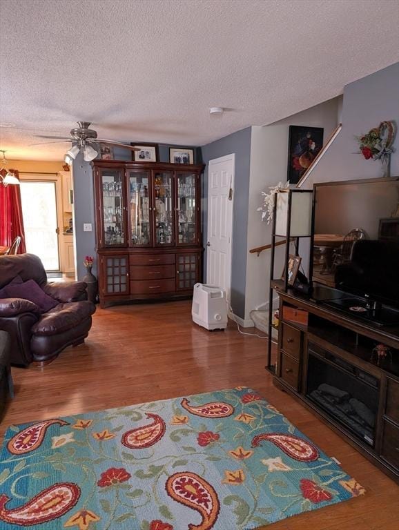 living room with hardwood / wood-style flooring and a textured ceiling