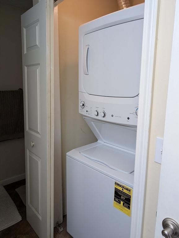 laundry area with stacked washer and clothes dryer