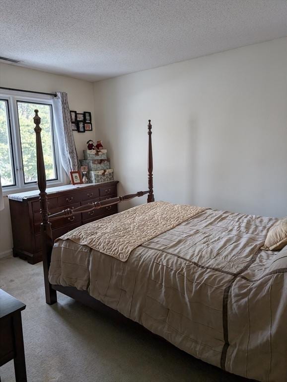 carpeted bedroom featuring a textured ceiling