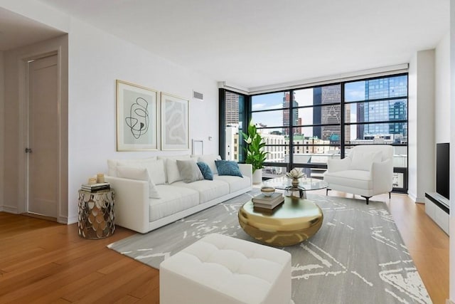 living room featuring light hardwood / wood-style flooring and floor to ceiling windows