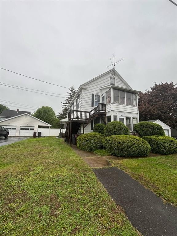 12 Woodmont St, Westfield, MA 01085 - view of side of home with a lawn, a garage, and stairway