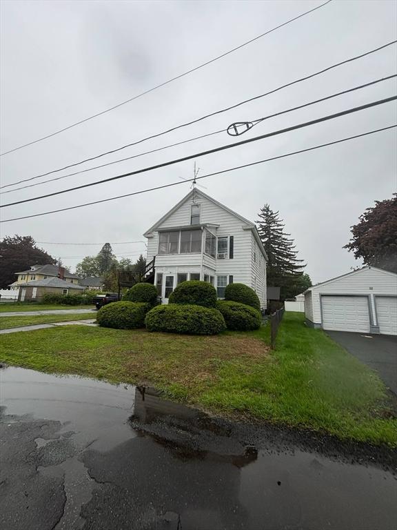 12 Woodmont St, Westfield, MA 01085 - view of front of home featuring an outbuilding, a front yard, and a garage